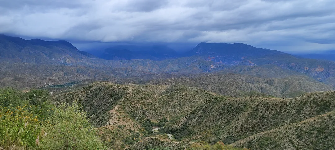 Camino de montaña tallado en la sierra árida bajo cielo nublado, evocando la carretera y el encuentro con uno mismo.